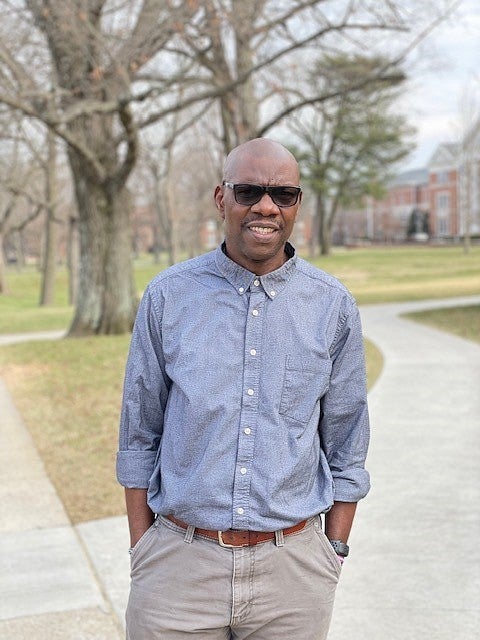 Jean Faye ENVS alum portrait with college campus in background