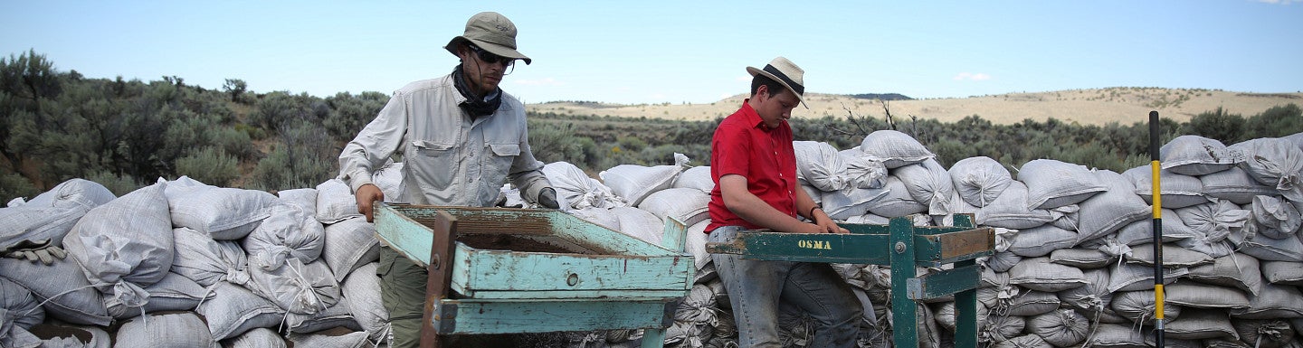 student and professor doing field work on location