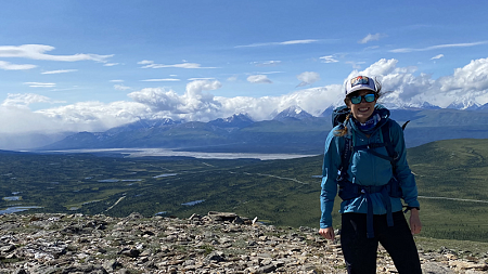 Sarah Cooley stands on a mountain 