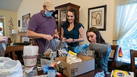 shawna heurgue and family members filling bags with supplies for the homeless