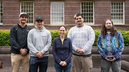 students and an instructor outside the library