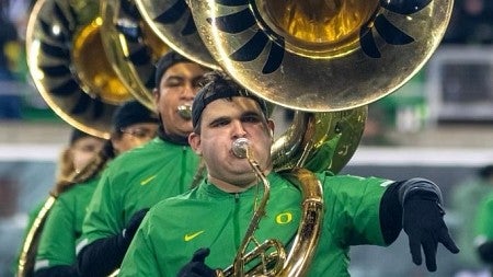 a student plays an instrument with the Oregon marching band