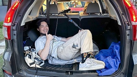 a student in the trunk of a SUV