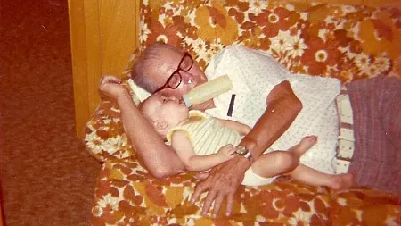 an upload of a photo of a baby and his grandfather from the 1970s