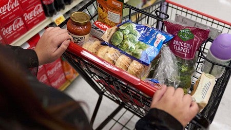 a shopping cart filled with veggies