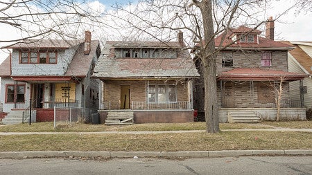 vacant houses in detroit, with a blue sky in the background