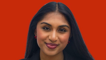 a headshot of Manju Bangalore with a red background
