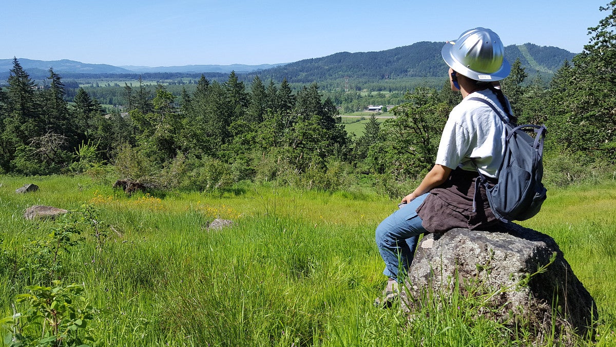 ELP student with hard hat looking at valley view