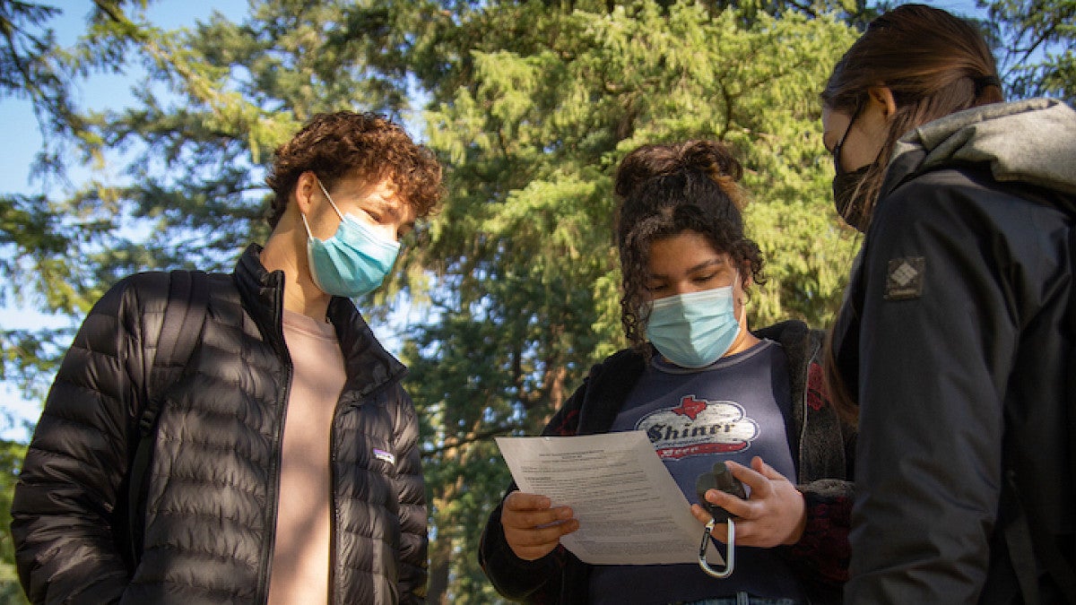 students outside with gps device