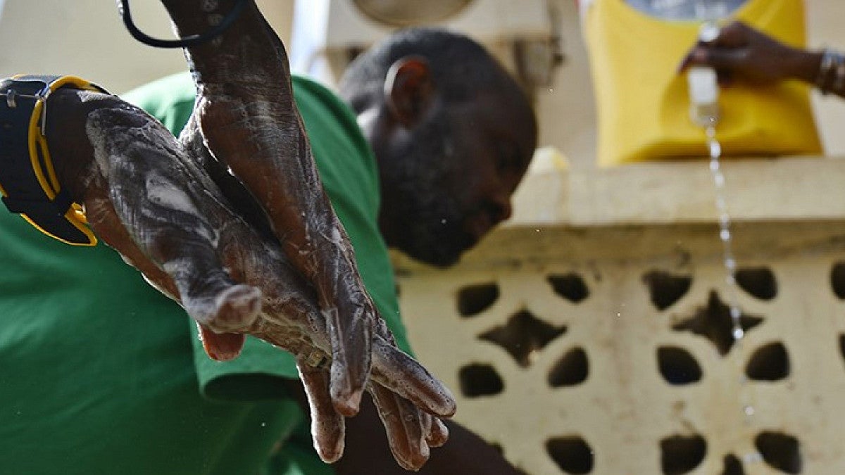 men washing their hands