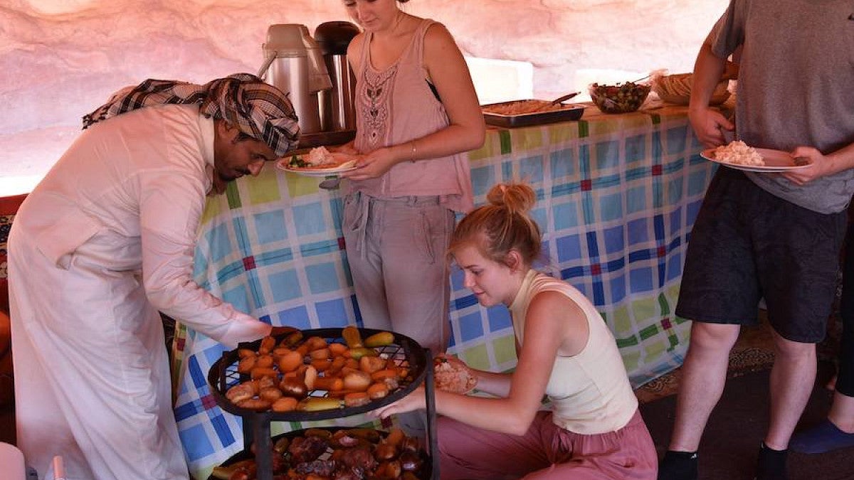 students at mealtime with bedouin hosts