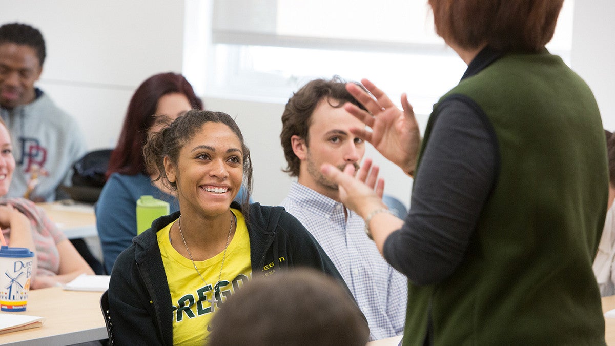 student smiling at teacher in classroom
