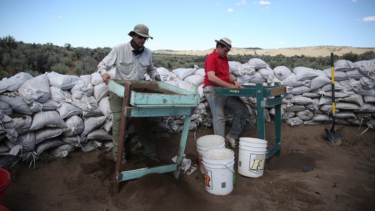 student and professor doing field work on location