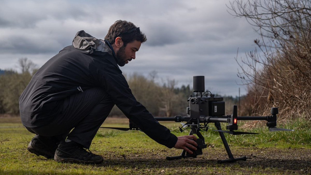 Student setting up drone
