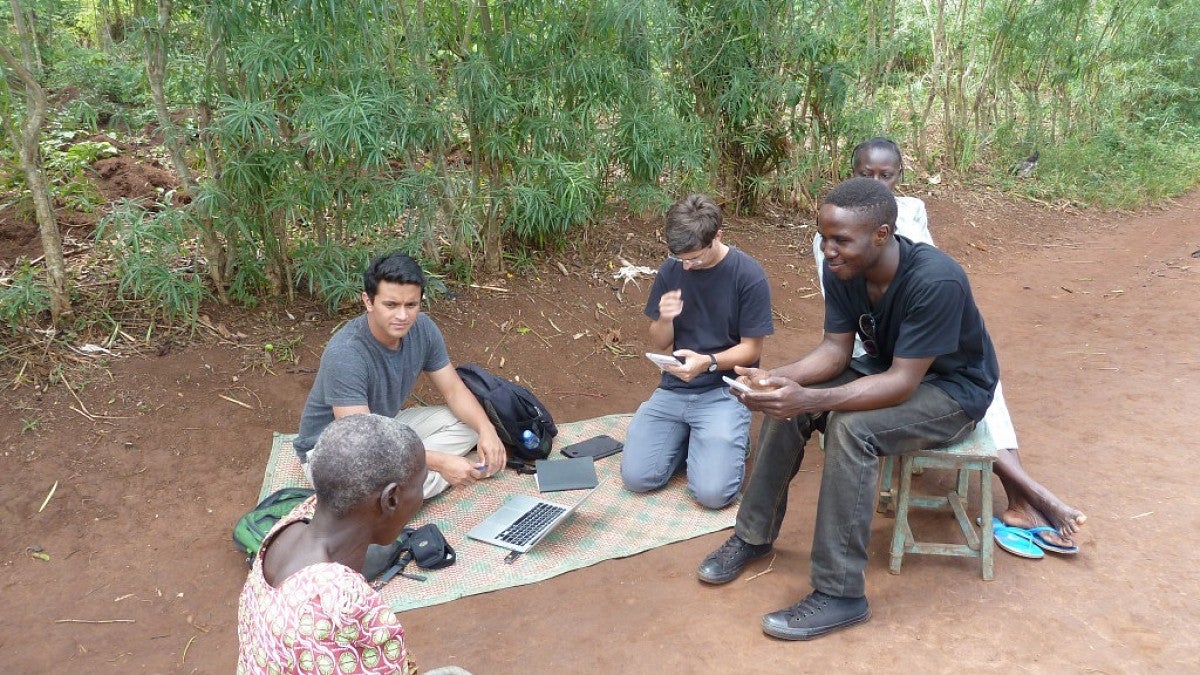 UO student and professor work with local residents in Uganda