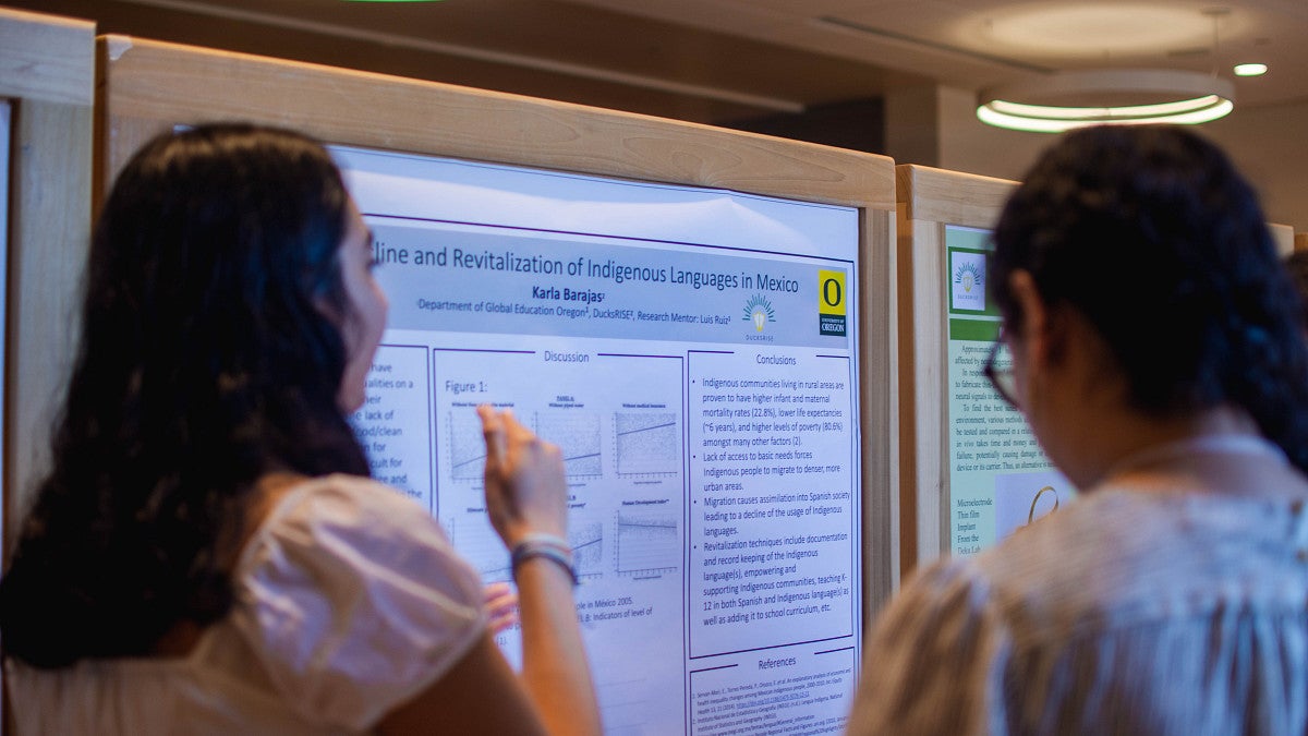 Students examining a poster presentation