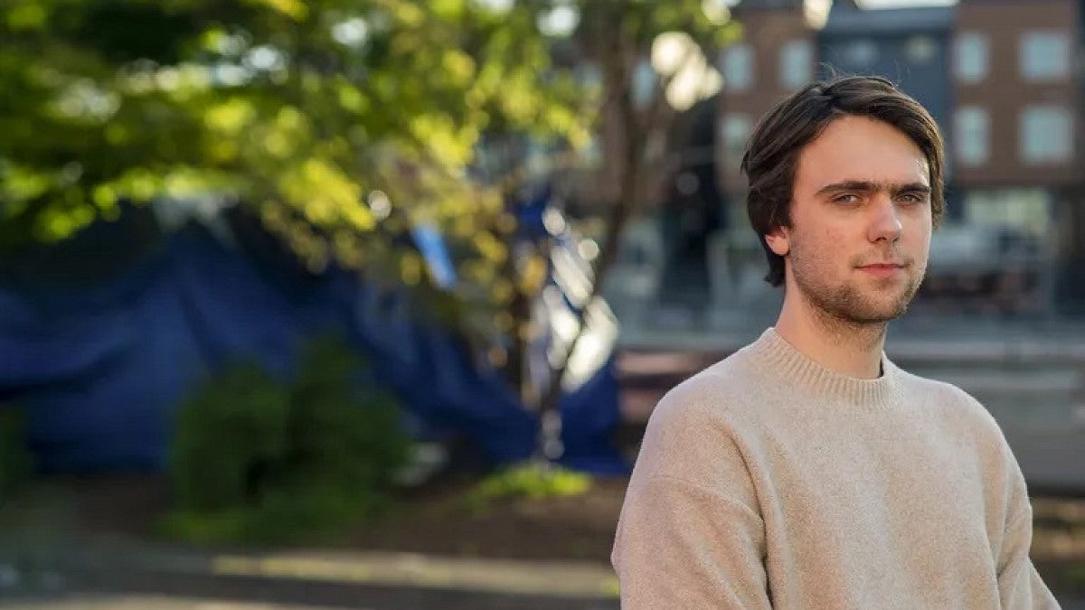 Photo of Jacob Hollenback in front of a tree and building