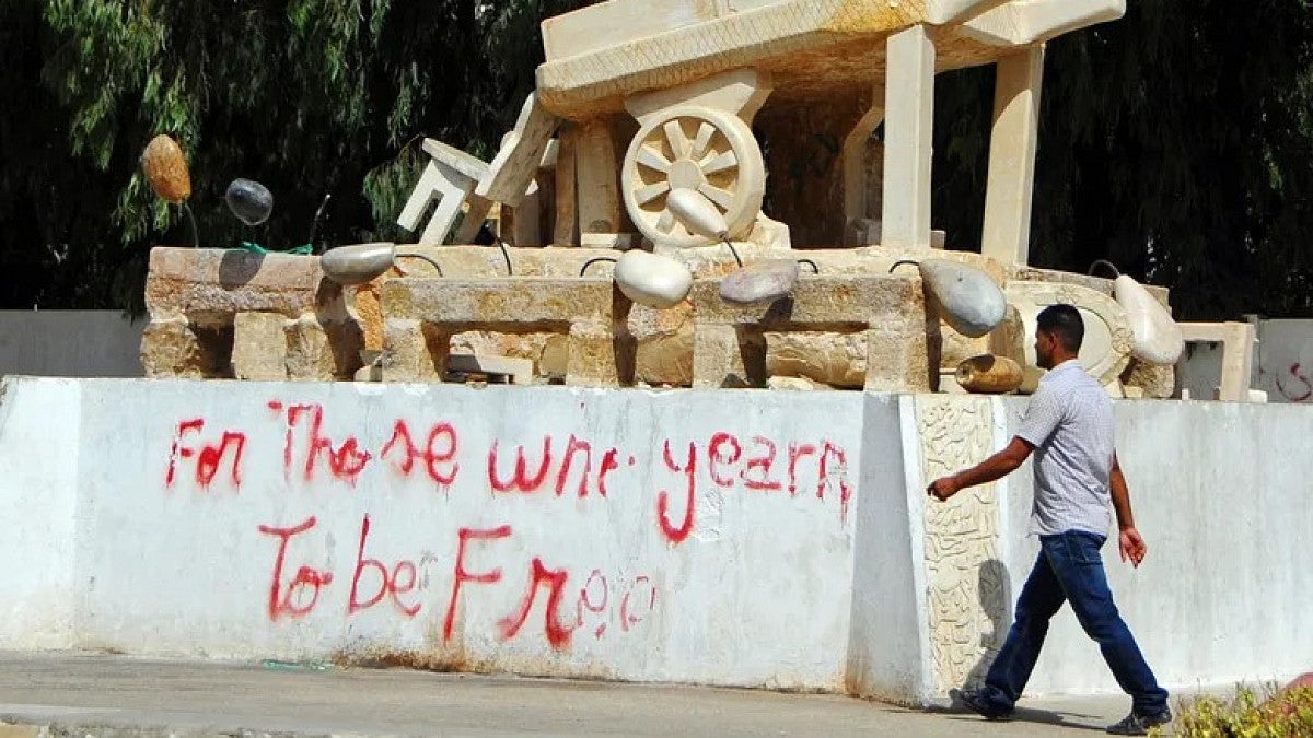 a man walks by a monument