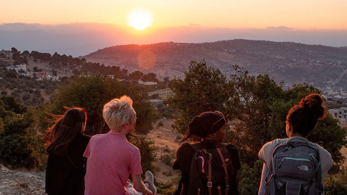 students sitting in Amman, Jordan, watching the sunset