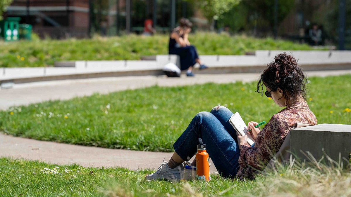a person sitting down reading a book