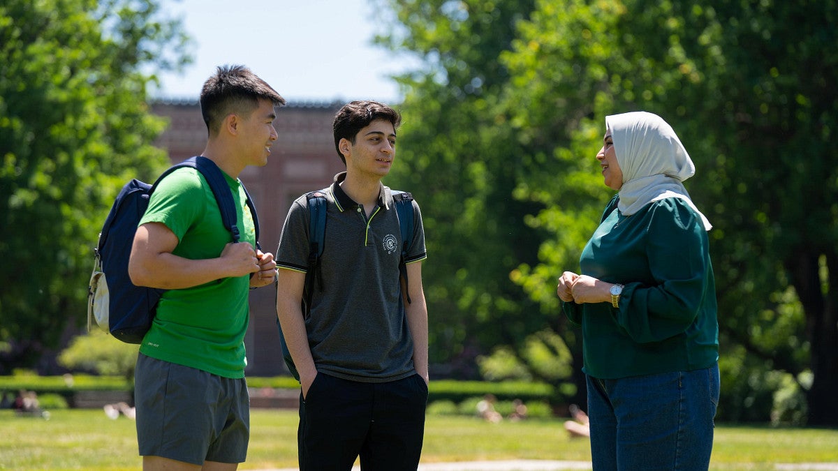 international students talking in a group outside