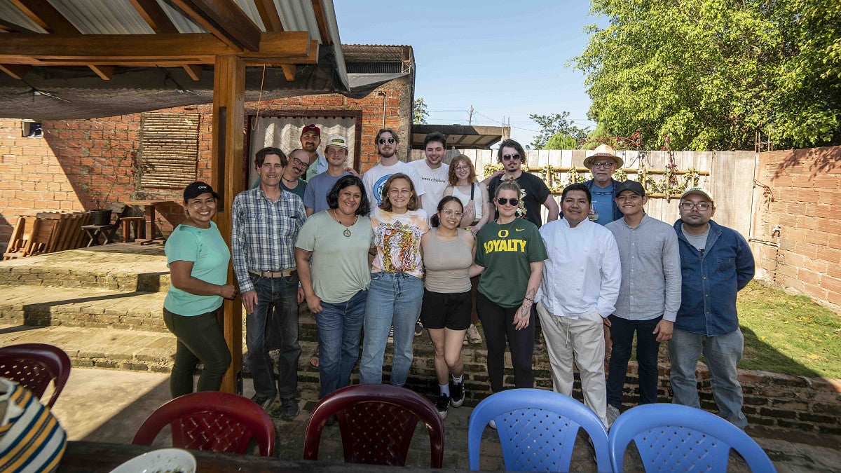 students gather for a photo outside