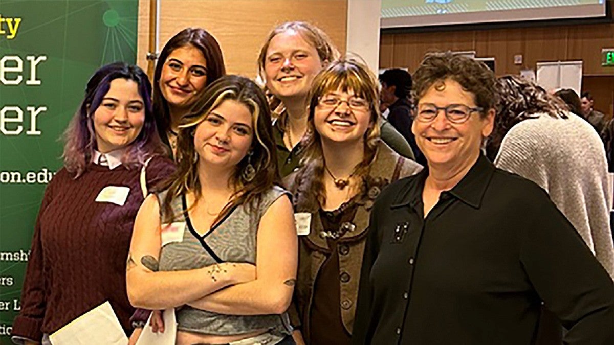 Students and Faculty posing together in a classroom