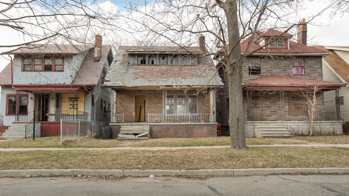 vacant houses in detroit, with a blue sky in the background