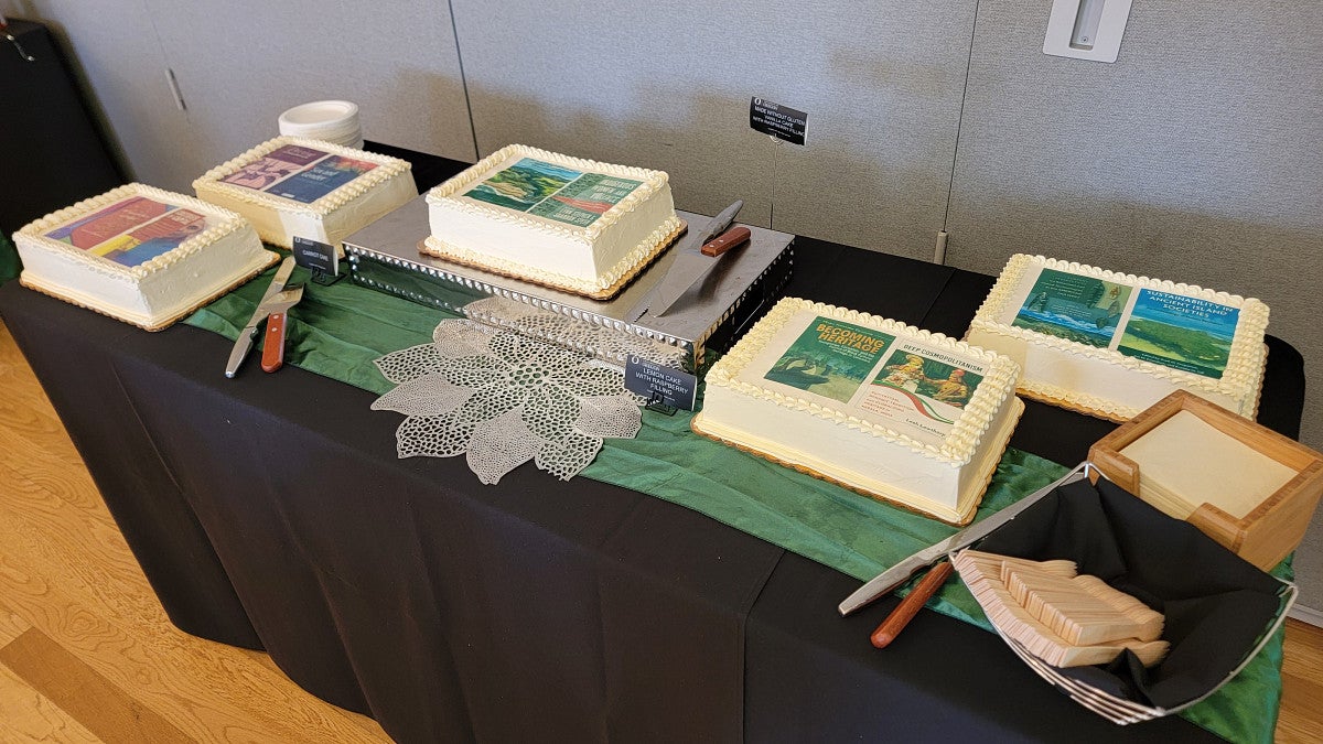 cakes on a table with book cover images on it