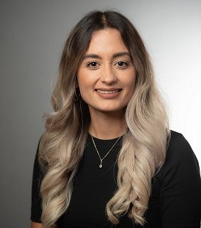 a headshot of Isabel Garcia Valdivia, with a gray background