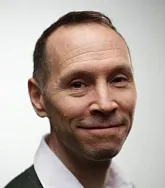 a headshot of a male with a white background