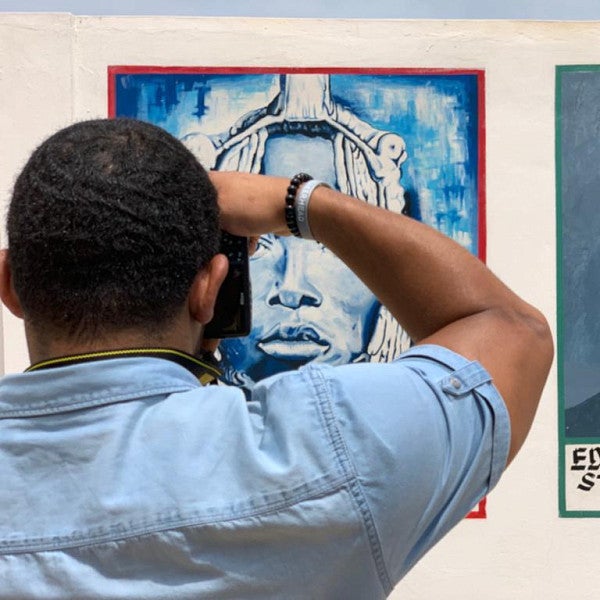 Student taking photos of art