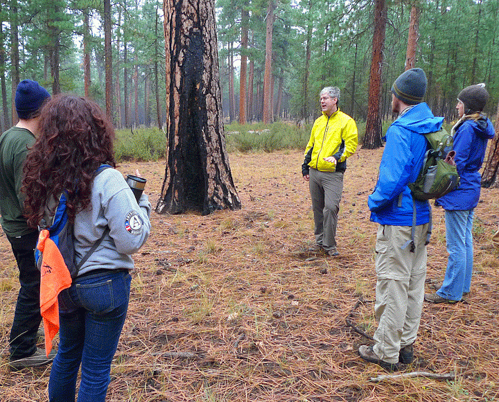 Geography professor Dan Gavin teaching a class in the wood