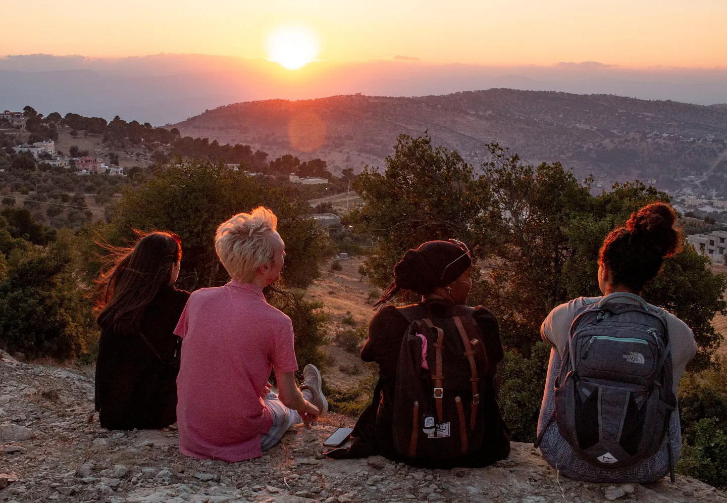 students sitting in Amman, Jordan, watching the sunset