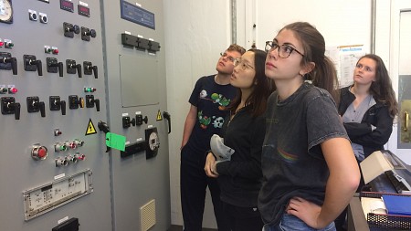 Students looking at control panel