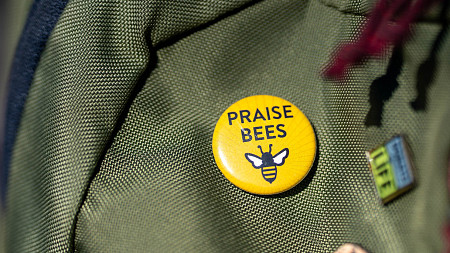 Praise Bees pin on a backpack 