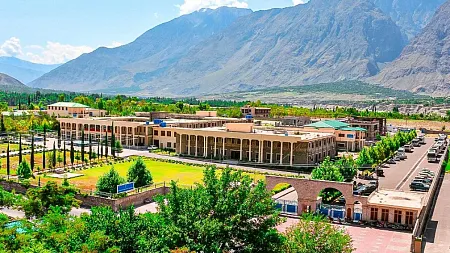 aerial shot of the main campus of karakoram international university in Pakistan, with mountains in background