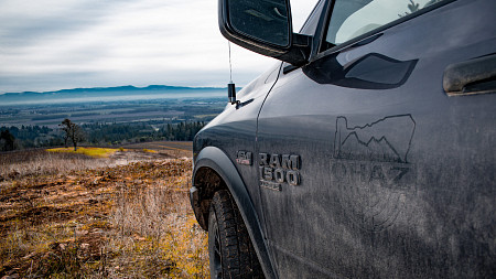 truck door with OHAZ logo in the foreground and an oregon landscape in the background
