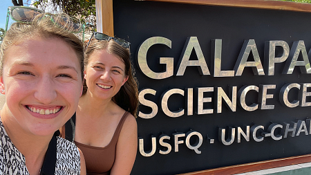 UO graduate students in front of a Galapagos Science Center sign