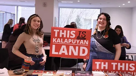 students with a yard sign