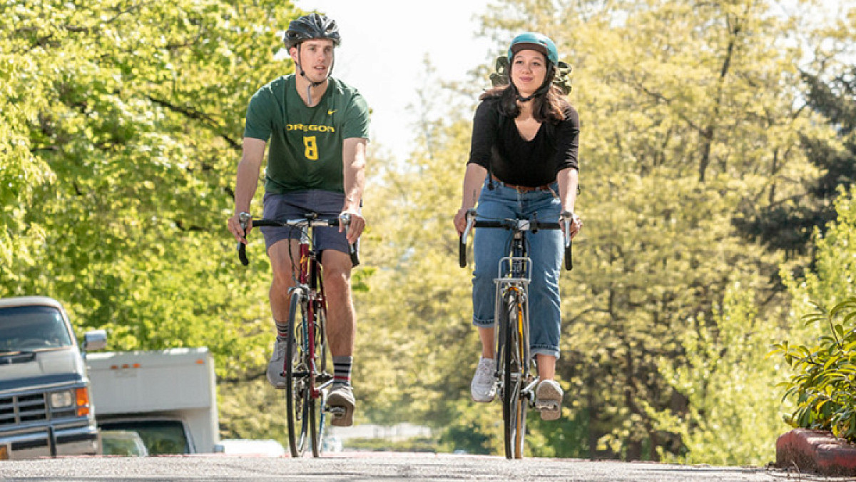 Two students biking in Eugene