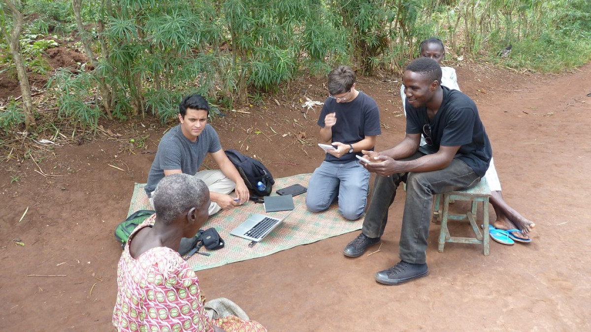 UO student and UO Economics Professor work with local residents to collect data on savings habits in a small community in Uganda