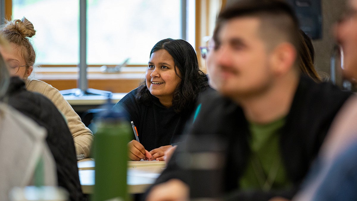 student in classroom smiling