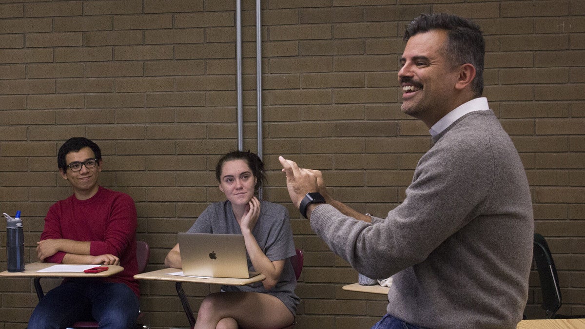 Faculty member Ernesto Martinez teaching students