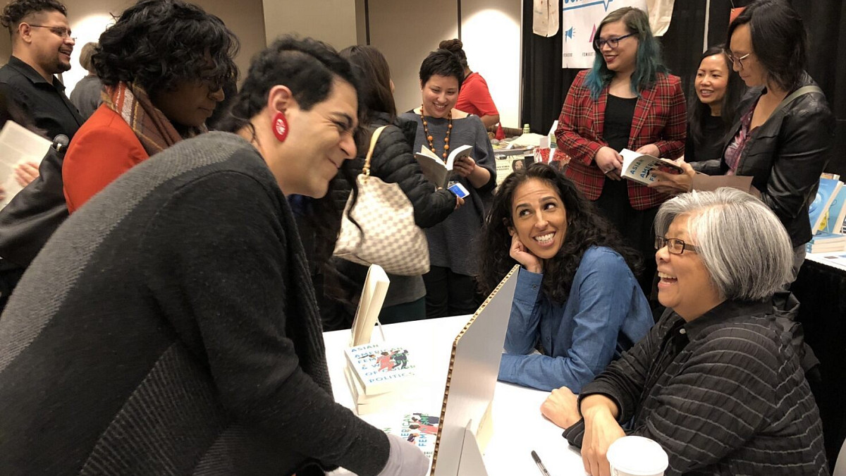 IRES faculty member Lynn Fujiwara talking to readers at a book signing