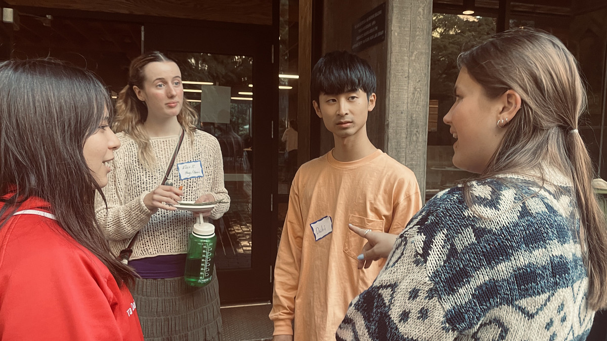 Photo of four students standing in the McKenzie courtyard in conversation