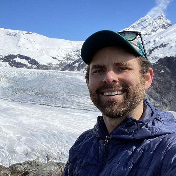 James Lamping and another person in front of a snowy mountain